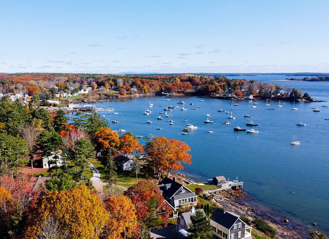 Kennebunk, ME Insurance - Aerial View of Coastal Harbor and of Lobster Boats with the Ocean Inside a Marina Sunset